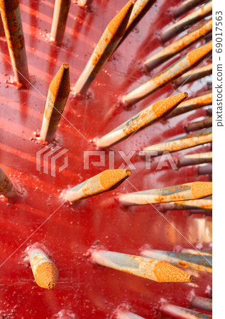 Close up picture of rusty spikes of an old spiked aerator roller Close up picture of rusty spikes of an old spiked aerator roller 69017563