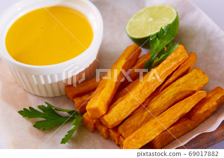 Oven-baked sweet potato fries, with a dipping sauce. Oven-baked sweet potato fries, with a dipping sauce. 69017882