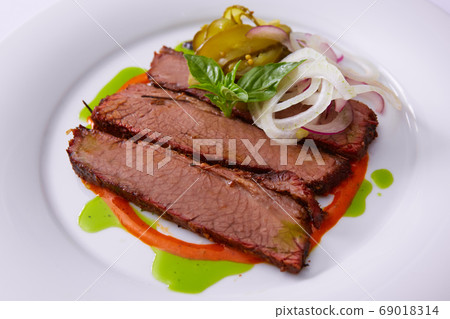 Beef Brisket Classic Texas Smoked BBQ Traditional Texas Smoke House Beef Brisket barbecue. Rubbed with spiced and slow smoked in a classic Texas smoke house over mesquite wood chips in smokehouse. 69018314
