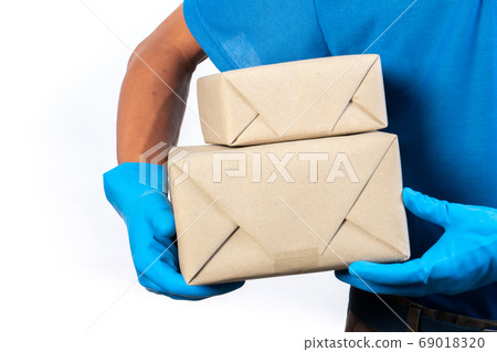 Delivery man holding and carrying a card box Delivery man holding and carrying a card box 69018320