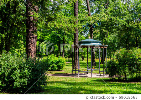 Wrought iron gazebo in a park at summer Wrought iron gazebo in a park at summer 69018565