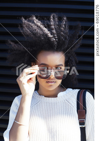 young pretty african girl posing cheerful on city background, lifestyle outdoor people concept young pretty african girl posing cheerful on city background, lifestyle outdoor people concept 69018776