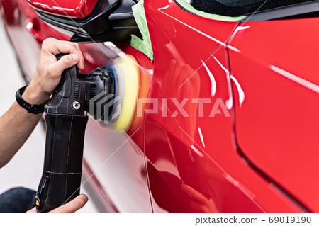 Man polishing car varnish with hand electric Man polishing car varnish with hand electric 69019190