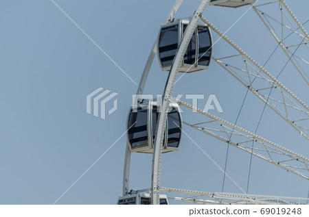 big wheel in the seaside village, in the big wheel in the seaside village, in the 69019248