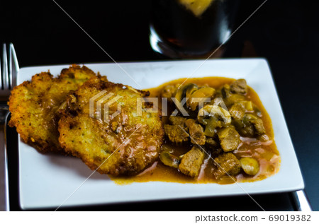 potato pancakes with spicy stew, delicious 69019382