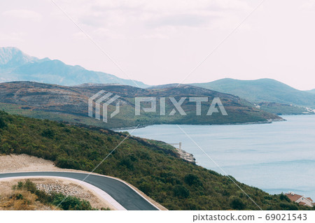 Black charred hills, after a forest fire, on the coast in Montenegro. Black charred hills, after a forest fire, on the coast in Montenegro. 69021543