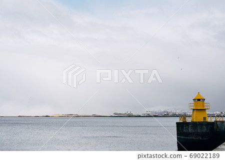 A large yellow lighthouse in Iceland, Reykjavik. 69022189