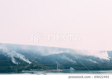 A huge column of smoke spreads across the Lustica peninsula in Montenegro, near the city of Krasici. A huge column of smoke spreads across the Lustica peninsula in Montenegro, near the city of Krasici. 69022491