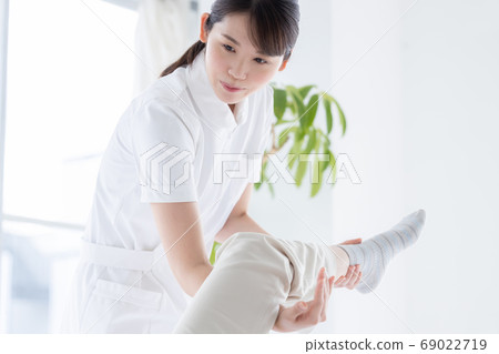 Medical physiotherapist and senior woman rehabilitating the foot 69022719