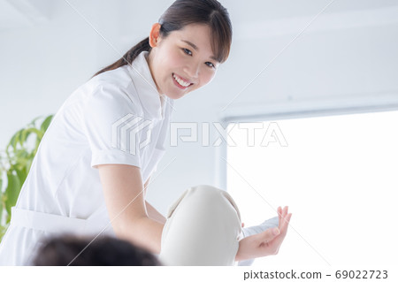 Medical physiotherapist and senior woman rehabilitating the foot Medical physiotherapist and senior woman rehabilitating the foot 69022723