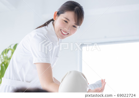 Medical physiotherapist and senior woman rehabilitating the foot 69022724