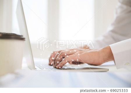 Close up image of businessman hands working computer laptop on desk in office room 69025333