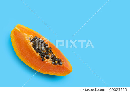 Papaya fruit on blue background. 69025523