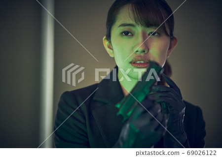 A woman with a gun A woman with a gun 69026122