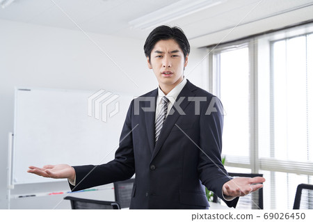 Japanese male businessman having a discussion in a conference room 69026450