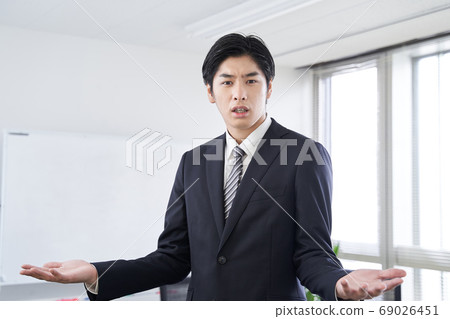 Japanese male businessman having a discussion in a conference room 69026451
