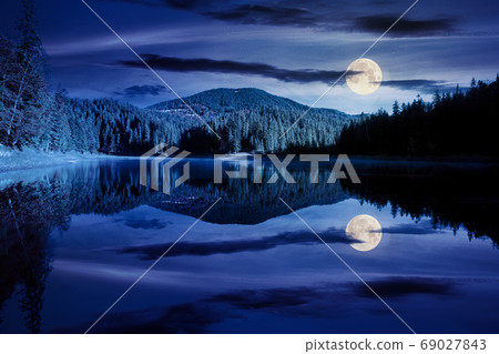 mountain lake among the forest at night. trees in colorful folia 69027843