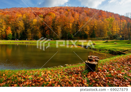 small lake in autumn park. forest on the hills in fall colors. g 69027879