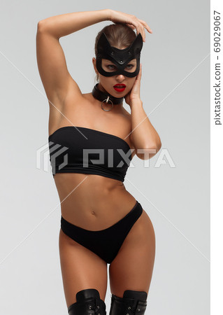 Seductive brunette in BDSM costume 69029067