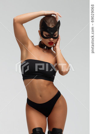 Seductive brunette in BDSM costume 69029068