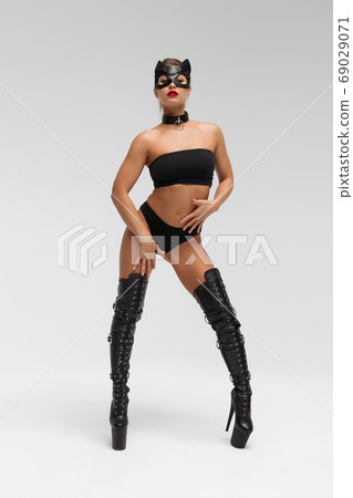 Seductive brunette in BDSM costume Seductive brunette in BDSM costume 69029071
