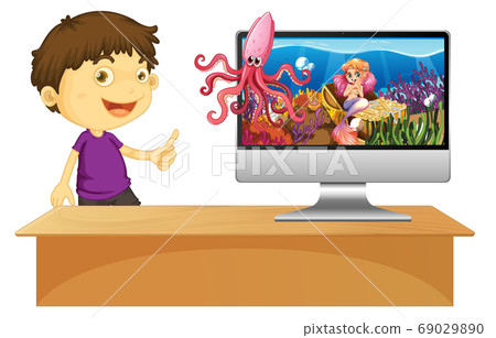 Happy boy next to computer with underwater scene 69029890