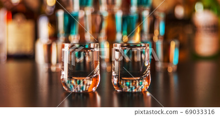 Traditional pure vodka in glasses on a black 69033316