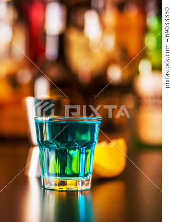 Popular blue drink shot kamikaze on the background Popular blue drink shot kamikaze on the background 69033330