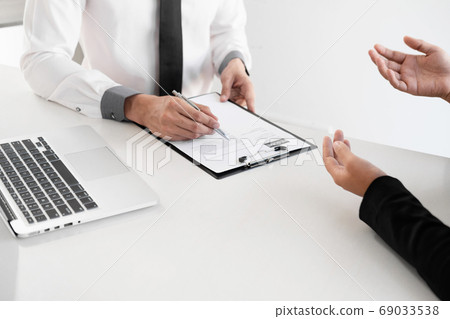 Office executives are interviewing job applicants in the meeting room Office executives are interviewing job applicants in the meeting room 69033538