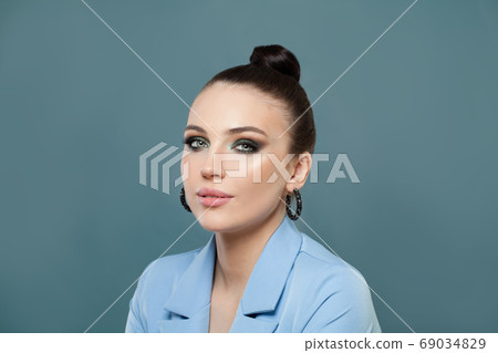 Cute woman brunette on blue background 69034829
