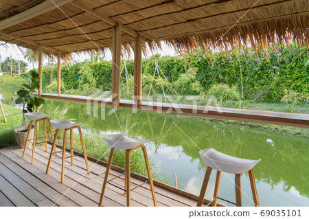 Wooden chairs in terrace restaurant in empty cafe. Interior desi 69035101