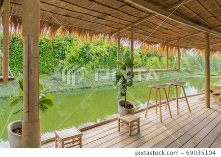 Wooden chairs in terrace restaurant in empty cafe. Interior desi Wooden chairs in terrace restaurant in empty cafe. Interior desi 69035104