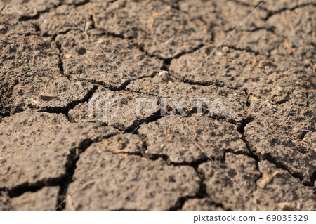 Dry ground rough cracks in the land with sand in desert. serious Dry ground rough cracks in the land with sand in desert. serious 69035329
