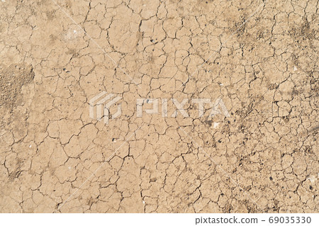 Dry ground rough cracks in the land with sand in desert. serious Dry ground rough cracks in the land with sand in desert. serious 69035330