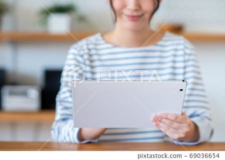 A young woman using a tablet A young woman using a tablet 69036654