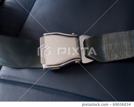 Safety seat belts on airplane chairs, Transportation and vehicle concept Safety seat belts on airplane chairs, Transportation and vehicle concept 69036834