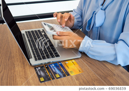 Business woman consumer spending via credit card and internet banking for shopping online Business woman consumer spending via credit card and internet banking for shopping online 69036839