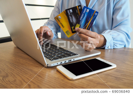 Business woman consumer spending via credit card and internet banking for shopping online Business woman consumer spending via credit card and internet banking for shopping online 69036840