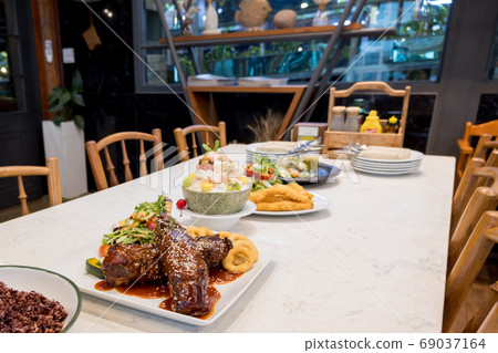 Steaks, Organic vegetables salads and fruit salad are prepared on the food table 69037164