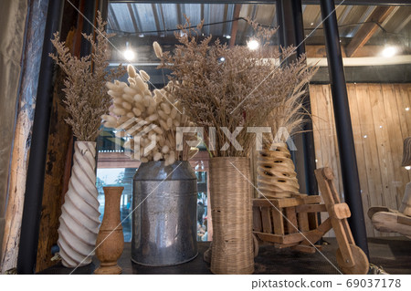 Brown dried flowers in various shape vases 69037178