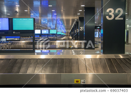Empty rows of conveyor belts for luggage at the 69037403