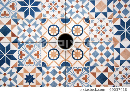 Cup of black coffee on colorful tile background top view Cup of black coffee on colorful tile background top view 69037418