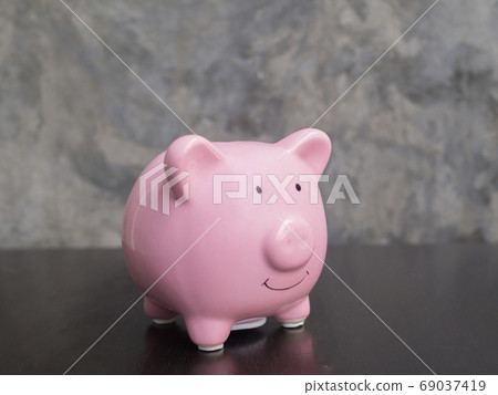 pink piggy bank on black cement wall background, Saving money for future plan and retirement fund 69037419