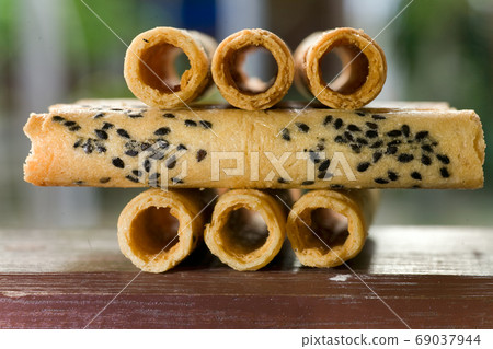 Big pile of fresh Wafer rolls with sesame Big pile of fresh Wafer rolls with sesame 69037944