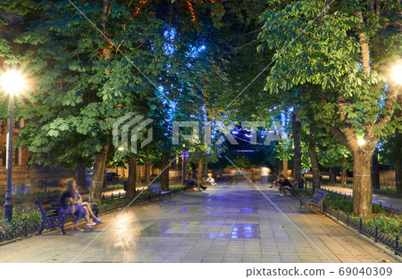 night view of Primorsky boulevard in Odessa city, Ukraine. Beautiful city Park and street illumination, walking people night view of Primorsky boulevard in Odessa city, Ukraine. Beautiful city Park and street illumination, walking people 69040309