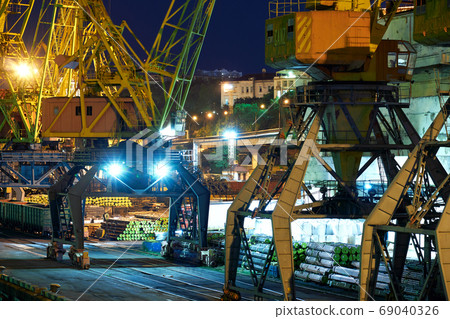 view of the industrial port at night - ships waiting for loading and unloading, cargo transportation by sea 69040326