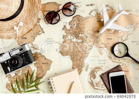 Planning vacation, travel plan, trip vacation using world map along with other travel accessories. Top view, flat lay. Planning vacation, travel plan, trip vacation using world map along with other travel accessories. Top view, flat lay. 69042078