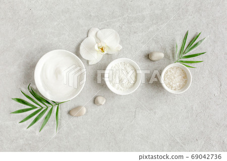 Female skin and body care cosmetic products set: facial cream, cosmetic clay, sea salt on gray marble background. Beauty blogger, salon treatments  69042736