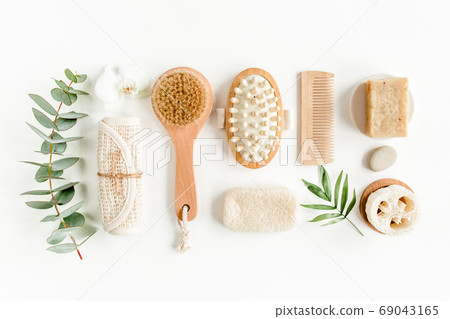Spa Background. Natural, Organic spa cosmetics products, eco friendly bathroom accessories, eucalyptus leaves. Skincare concept on white background.  69043165