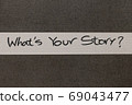 White and Grey coloured paper background with Whats Your Story motivational handwritten message 69043477